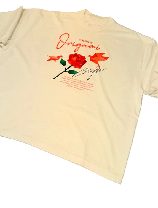 An off-white short-sleeve t-shirt laid flat on a white surface, featuring a graphic print of an origami rose with red birds and the word 'Origami' in red script.
