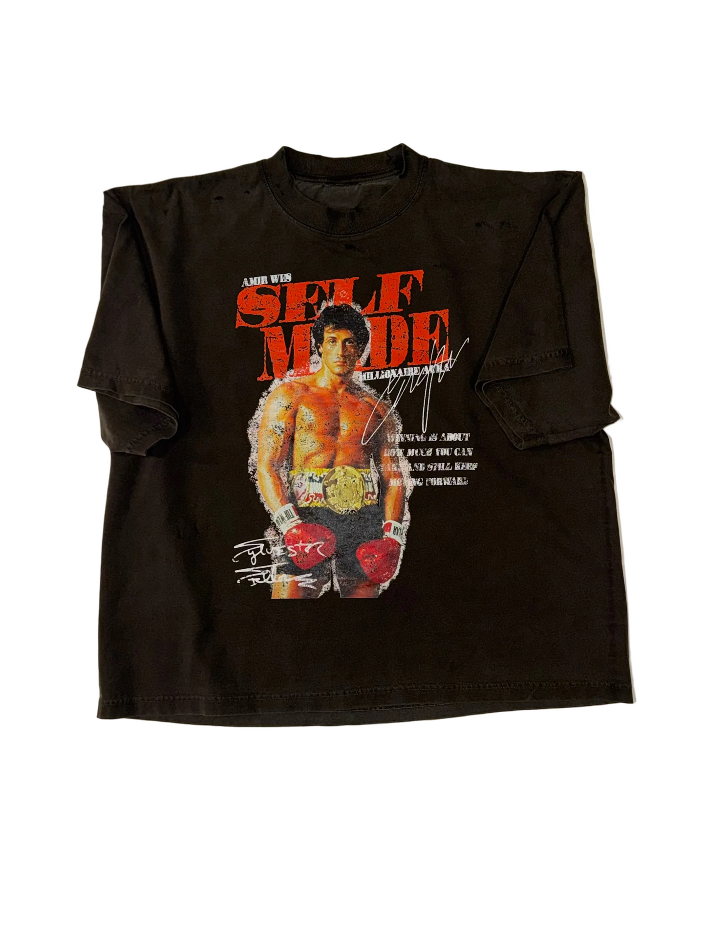 A dark gray short-sleeve graphic t-shirt featuring a printed image of Rocky Balboa from 'Rocky' with the words 'SELF MADE' in red and white, laid flat on a white background.